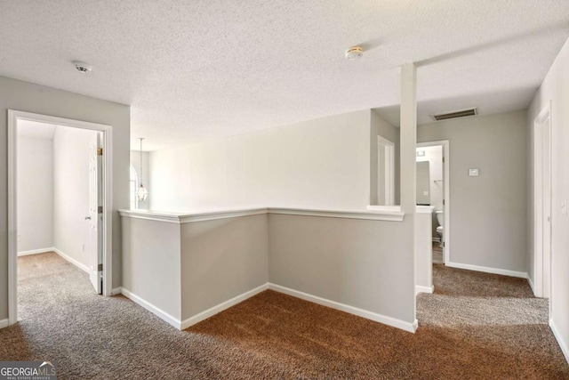 3731 Laramie Rd, Ellenwood, GA 30294 - hallway featuring carpet, a textured ceiling, and baseboards