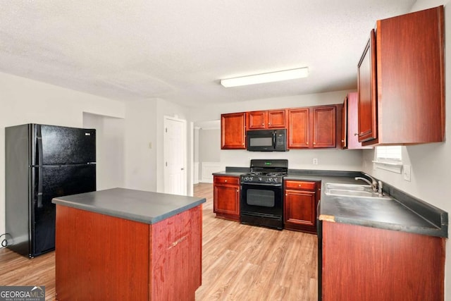 3731 Laramie Rd, Ellenwood, GA 30294 - kitchen featuring black appliances, dark countertops, light wood-style floors, a sink, and a kitchen island