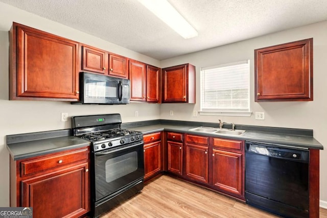 3731 Laramie Rd, Ellenwood, GA 30294 - kitchen featuring black appliances, a sink, light wood-type flooring, dark brown cabinets, and dark countertops