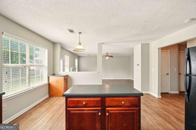 3731 Laramie Rd, Ellenwood, GA 30294 - kitchen featuring dark brown cabinets, freestanding refrigerator, light wood-style flooring, ceiling fan, and a textured ceiling
