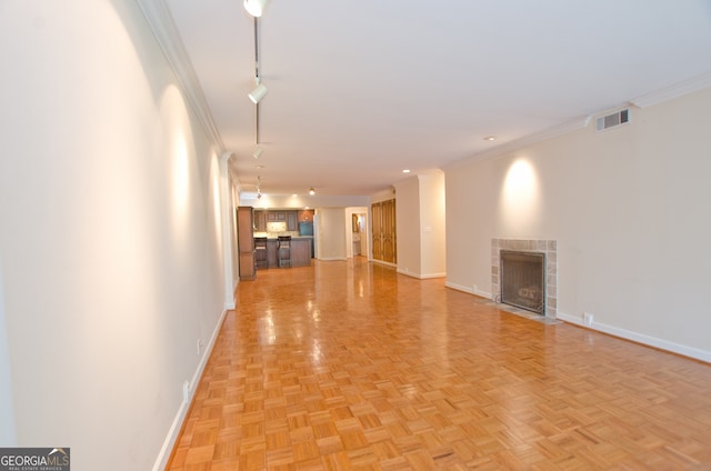 2734 Peachtree Rd NW Unit C-404, Atlanta, GA 30305 - unfurnished living room featuring rail lighting, baseboards, a tile fireplace, and crown molding