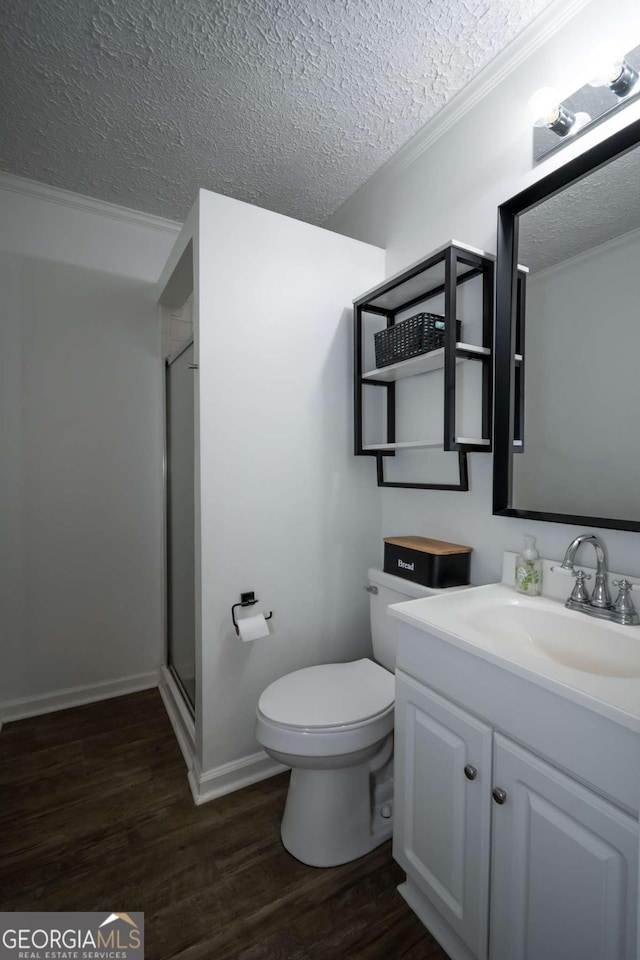 2060 Simonton Bridge Rd, Watkinsville, GA 30677 - bathroom with a textured ceiling, vanity, wood finished floors, toilet, and a shower stall