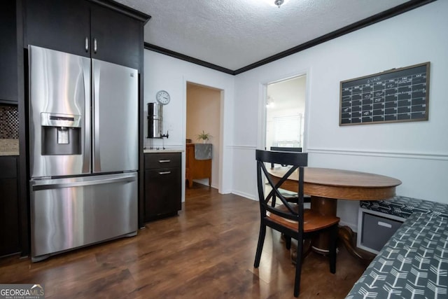 2060 Simonton Bridge Rd, Watkinsville, GA 30677 - kitchen with stainless steel fridge, crown molding, dark cabinetry, dark wood finished floors, and a textured ceiling