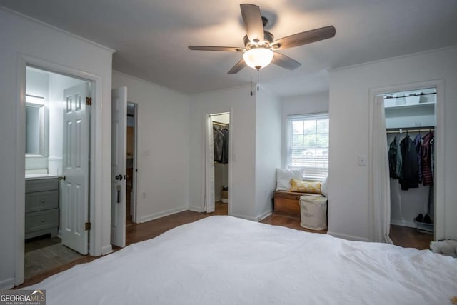2060 Simonton Bridge Rd, Watkinsville, GA 30677 - bedroom featuring a walk in closet, connected bathroom, baseboards, a ceiling fan, and ornamental molding