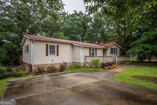 2060 Simonton Bridge Rd, Watkinsville, GA 30677 - view of front facade with a wooden deck, metal roof, and a front lawn