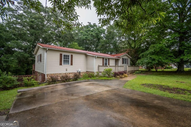 2060 Simonton Bridge Rd, Watkinsville, GA 30677 - view of front of property featuring a wooden deck, metal roof, a front lawn, and driveway