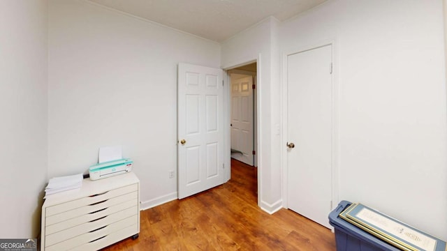 2060 Simonton Bridge Rd, Watkinsville, GA 30677 - home office with crown molding, wood finished floors, and baseboards