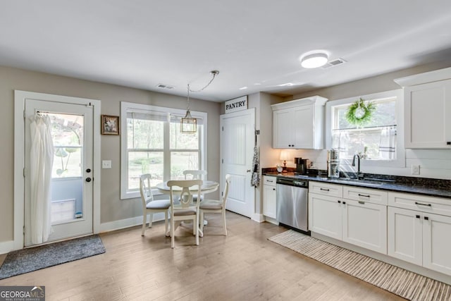6540 Terracewood Ln, Gainesville, GA 30506 - kitchen featuring stainless steel dishwasher, a sink, light wood-style flooring, and plenty of natural light
