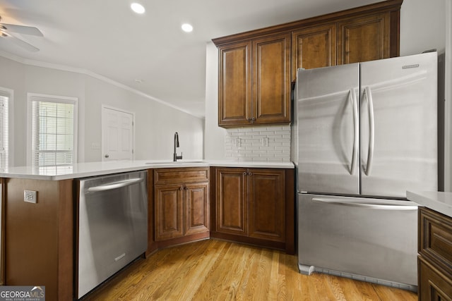 85 Bloomfield Way, Sharpsburg, GA 30277 - kitchen with appliances with stainless steel finishes, a sink, a peninsula, ceiling fan, and crown molding