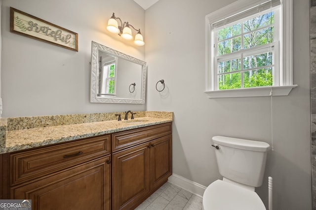 85 Bloomfield Way, Sharpsburg, GA 30277 - bathroom featuring marble look tile flooring, baseboards, vanity, and toilet