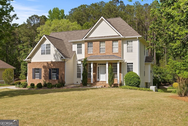 85 Bloomfield Way, Sharpsburg, GA 30277 - traditional-style home featuring a front lawn, brick siding, and roof with shingles