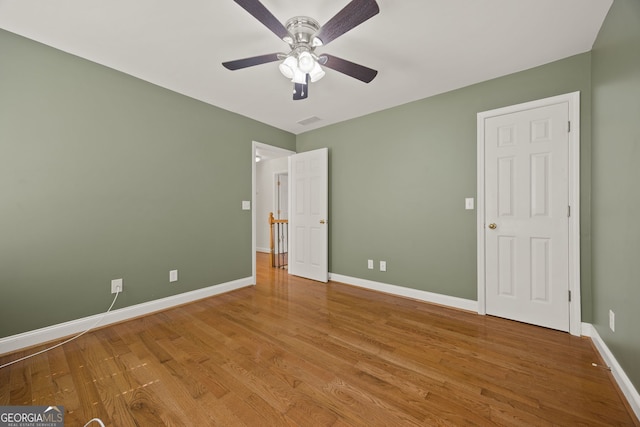 85 Bloomfield Way, Sharpsburg, GA 30277 - unfurnished bedroom with wood finished floors, baseboards, and a ceiling fan