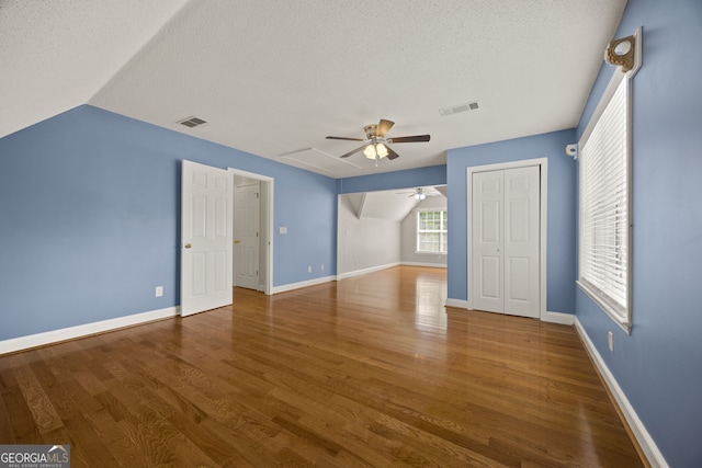85 Bloomfield Way, Sharpsburg, GA 30277 - additional living space featuring ceiling fan, a textured ceiling, wood finished floors, baseboards, and lofted ceiling