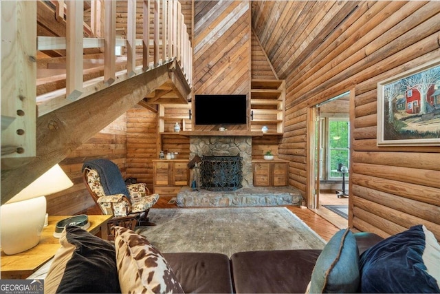 15 Bailey St, Whitesburg, GA 30185 - living area featuring rustic walls, a fireplace, wood finished floors, wooden ceiling, and a towering ceiling