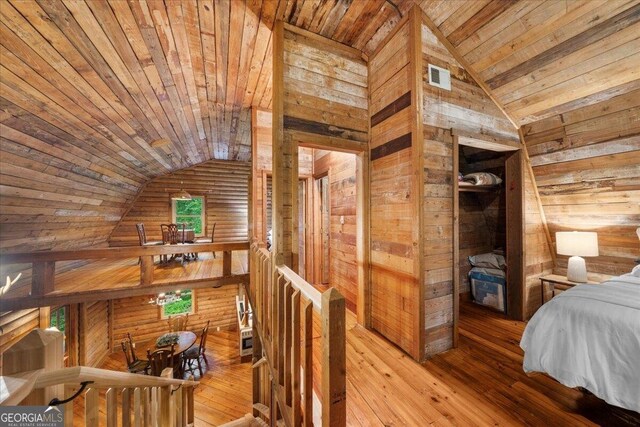 15 Bailey St, Whitesburg, GA 30185 - bedroom with wood walls, vaulted ceiling, wood ceiling, and hardwood / wood-style floors