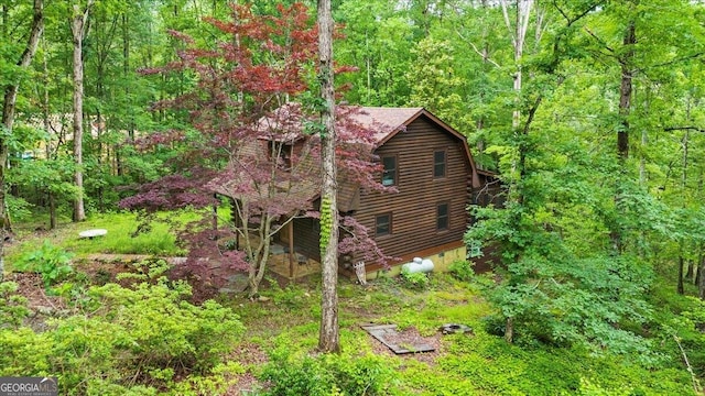 15 Bailey St, Whitesburg, GA 30185 - view of side of home with log exterior, a forest view, and a gambrel roof