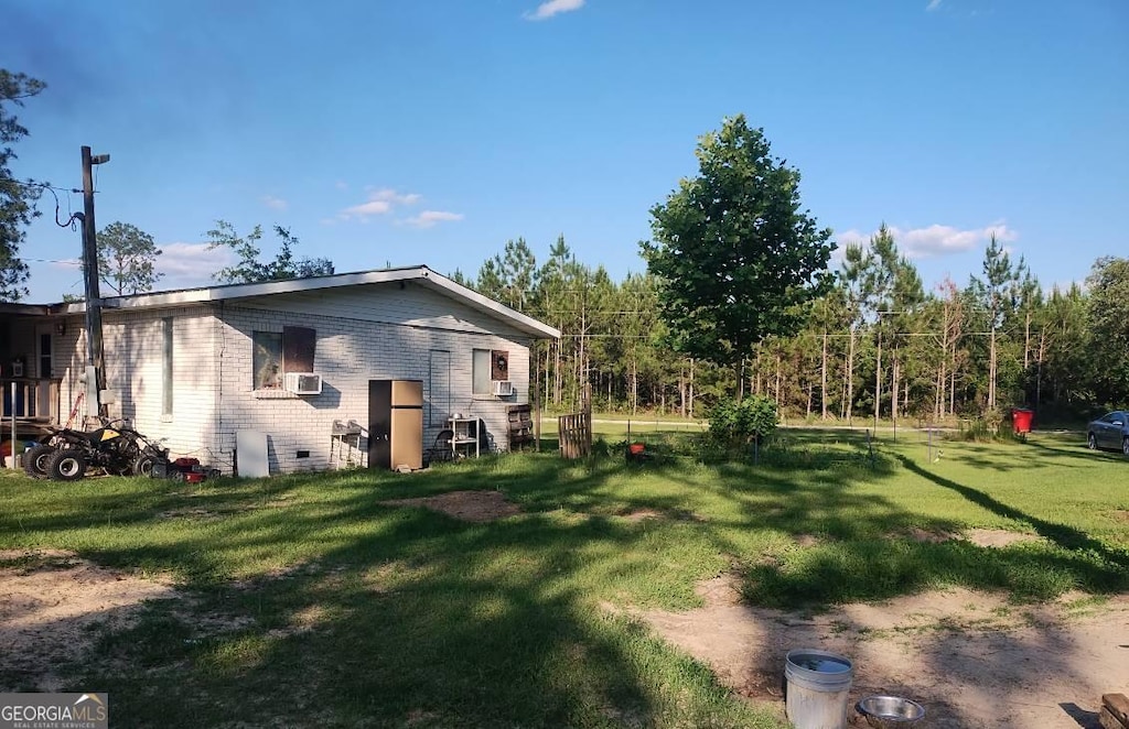 231 Pine Dr, Waycross, GA 31503 - view of grassy yard with cooling unit