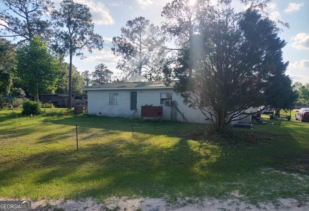 231 Pine Dr, Waycross, GA 31503 - back of property with brick siding and a lawn