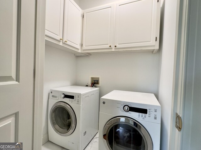 11 Stonegable Dr NW, Rome, GA 30165 - laundry area featuring washing machine and clothes dryer, cabinet space, and marble look tiles