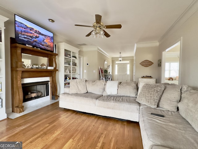 11 Stonegable Dr NW, Rome, GA 30165 - living room with a ceiling fan, a fireplace with flush hearth, ornamental molding, and light wood finished floors