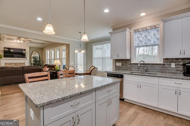 895 Lillian Park Dr, Grovetown, GA 30813 - kitchen with a sink, dishwasher, light wood-style flooring, crown molding, and a kitchen island