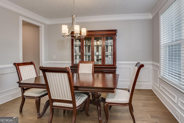 895 Lillian Park Dr, Grovetown, GA 30813 - dining room with a chandelier, ornamental molding, a wainscoted wall, a decorative wall, and wood finished floors
