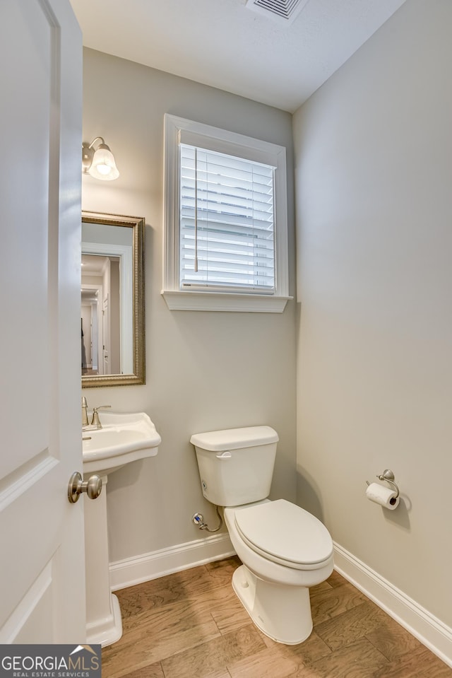 895 Lillian Park Dr, Grovetown, GA 30813 - half bathroom featuring toilet, baseboards, and wood finished floors