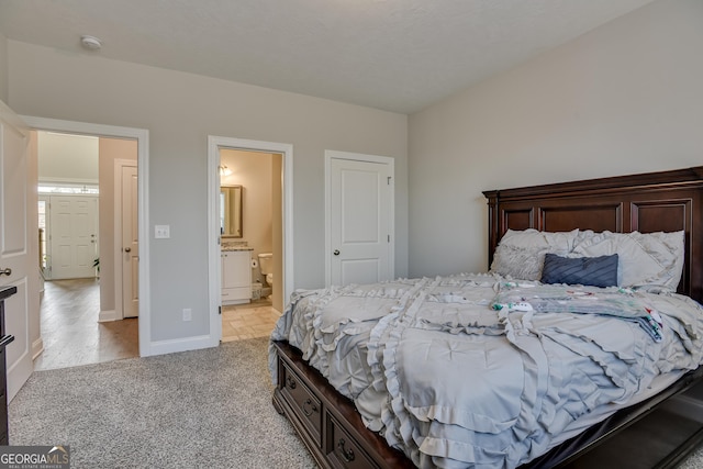 895 Lillian Park Dr, Grovetown, GA 30813 - bedroom with light colored carpet, connected bathroom, and baseboards