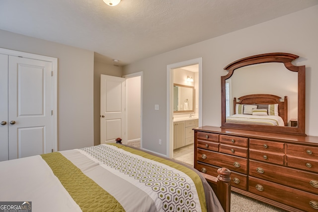 895 Lillian Park Dr, Grovetown, GA 30813 - bedroom with light colored carpet, a closet, ensuite bathroom, and baseboards