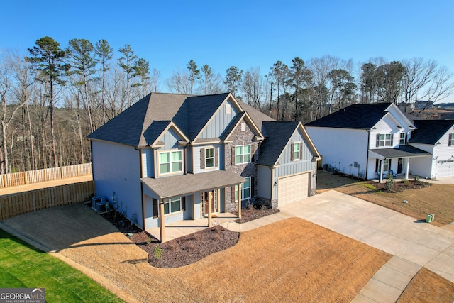 895 Lillian Park Dr, Grovetown, GA 30813 - craftsman house with board and batten siding, covered porch, concrete driveway, a shingled roof, and an attached garage