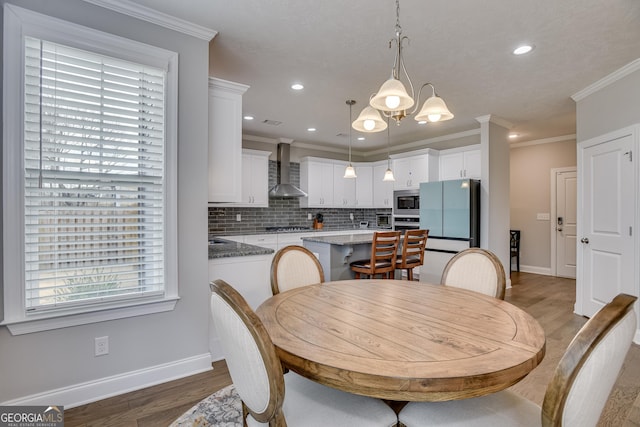 895 Lillian Park Dr, Grovetown, GA 30813 - dining space featuring baseboards, light wood-style flooring, recessed lighting, crown molding, and a chandelier