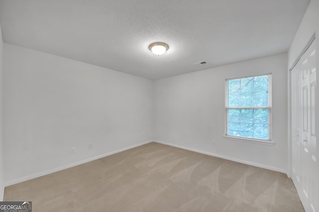 7459 Old Chapel, South Fulton, GA 30349 - empty room featuring light colored carpet and a textured ceiling