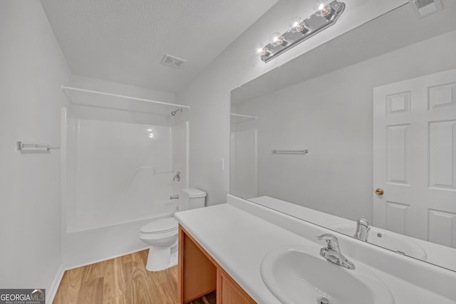 7459 Old Chapel, South Fulton, GA 30349 - bathroom with vanity, wood finished floors, shower / tub combination, and a textured ceiling