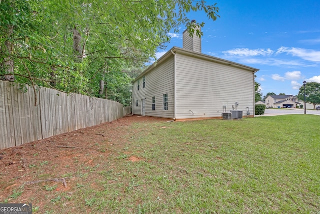 7459 Old Chapel, South Fulton, GA 30349 - view of home's exterior featuring a chimney and a central air condition unit