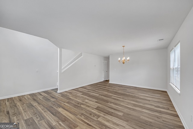 7459 Old Chapel, South Fulton, GA 30349 - unfurnished living room with a chandelier and wood finished floors