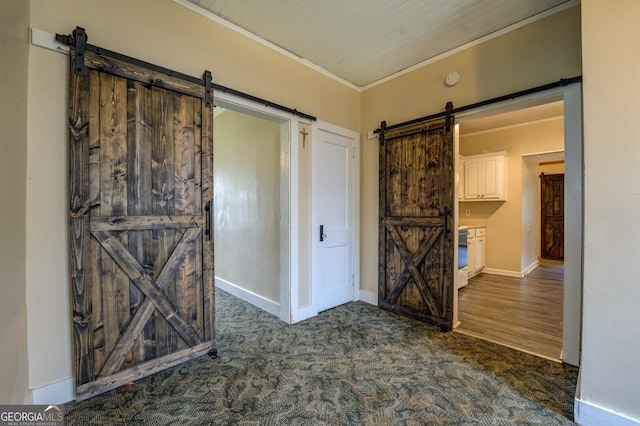 6 Mill St, Jackson, GA 30233 - spare room with a barn door, crown molding, baseboards, and dark carpet