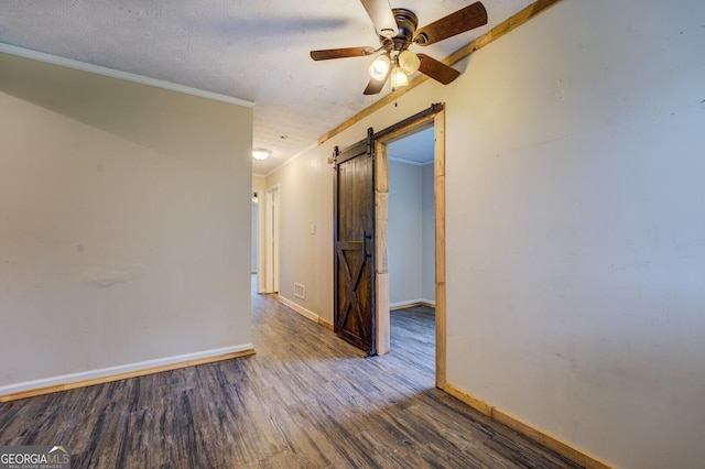 6 Mill St, Jackson, GA 30233 - unfurnished room with a barn door, wood finished floors, ceiling fan, baseboards, and crown molding