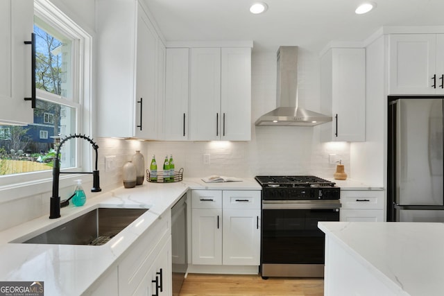 102 Rockyford Rd, Atlanta, GA 30317 - kitchen featuring stainless steel appliances, wall chimney exhaust hood, a sink, white cabinets, and recessed lighting