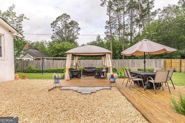 913 7th Ave, Albany, GA 31701 - fenced backyard with a gazebo, a wooden deck, and outdoor dining space