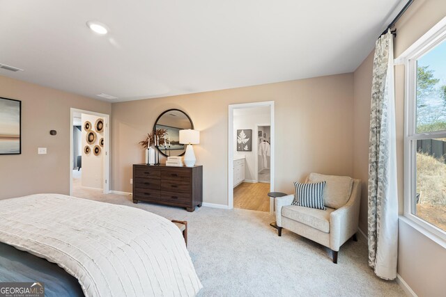 4036 Trimrose Ct Unit 70, Atlanta, GA 30349 - bedroom featuring light carpet, baseboards, and ensuite bath