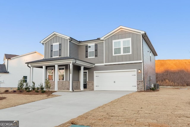 4036 Trimrose Ct Unit 70, Atlanta, GA 30349 - view of front of home featuring board and batten siding, concrete driveway, a garage, and brick siding