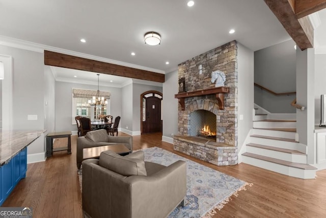 146 David Dr, Tiger, GA 30576 - living room with a stone fireplace, wood finished floors, a chandelier, stairway, and recessed lighting