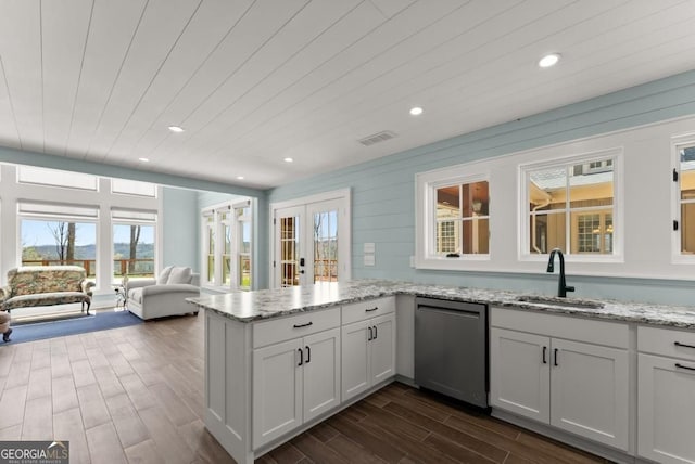 146 David Dr, Tiger, GA 30576 - kitchen with dishwasher, a peninsula, dark wood finished floors, light stone countertops, and recessed lighting