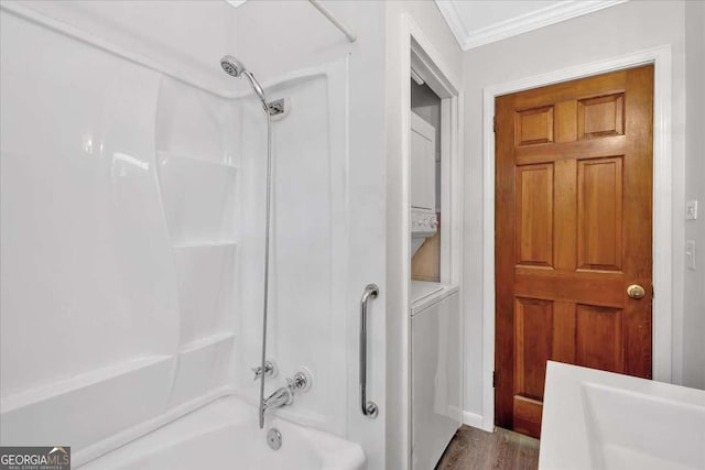 612 Oakcrest Dr, Rockmart, GA 30153 - bathroom featuring stacked washer / drying machine, shower / tub combination, crown molding, and wood finished floors