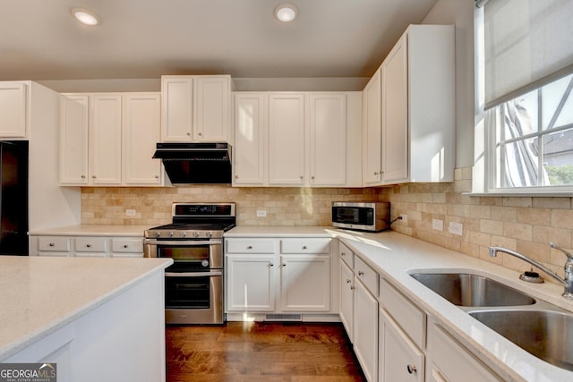 3360 Pickens St, Duluth, GA 30096 - kitchen featuring stainless steel appliances, a sink, extractor fan, white cabinets, and dark wood-type flooring