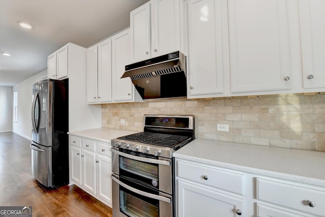 3360 Pickens St, Duluth, GA 30096 - kitchen with stainless steel appliances, range hood, dark wood finished floors, backsplash, and white cabinetry