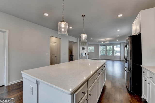 3360 Pickens St, Duluth, GA 30096 - kitchen with freestanding refrigerator, a kitchen island, dark wood-style flooring, recessed lighting, and white cabinetry