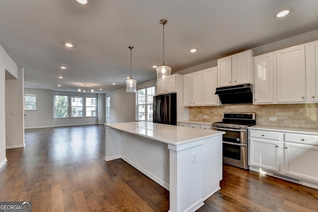3360 Pickens St, Duluth, GA 30096 - kitchen with freestanding refrigerator, range with two ovens, under cabinet range hood, a kitchen island, and backsplash