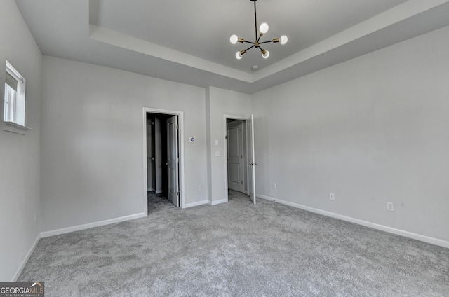 3360 Pickens St, Duluth, GA 30096 - unfurnished bedroom featuring a chandelier, carpet floors, baseboards, and a raised ceiling