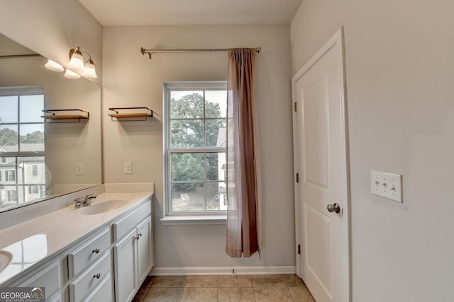 3360 Pickens St, Duluth, GA 30096 - bathroom featuring double vanity, healthy amount of natural light, baseboards, and tile patterned flooring